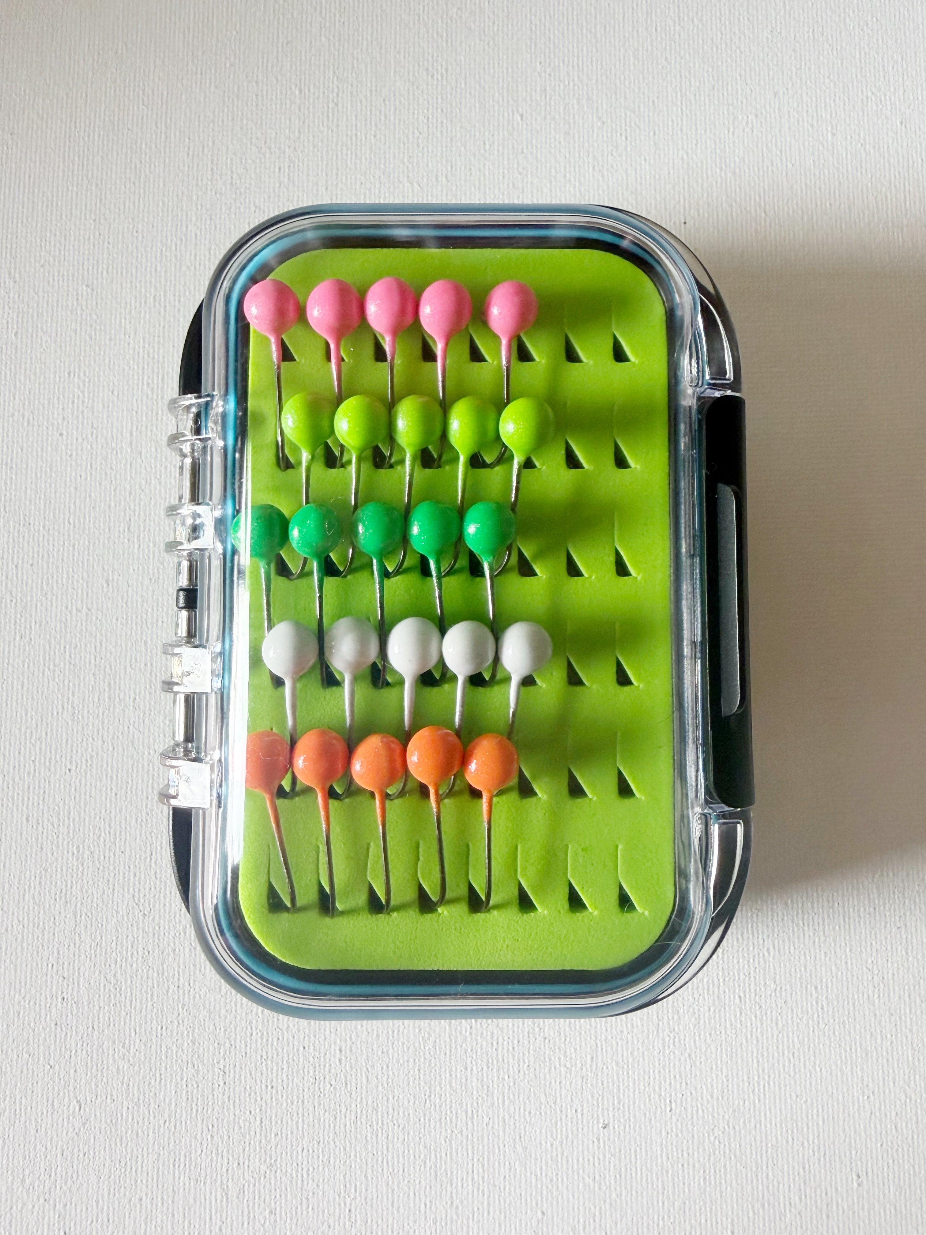 GEM Jigs box showing twenty five handcrafted 1/16oz panfish jigs.